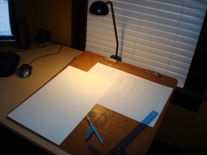 My desk, set up for illustrating, with my drawing board propped up next to my computer